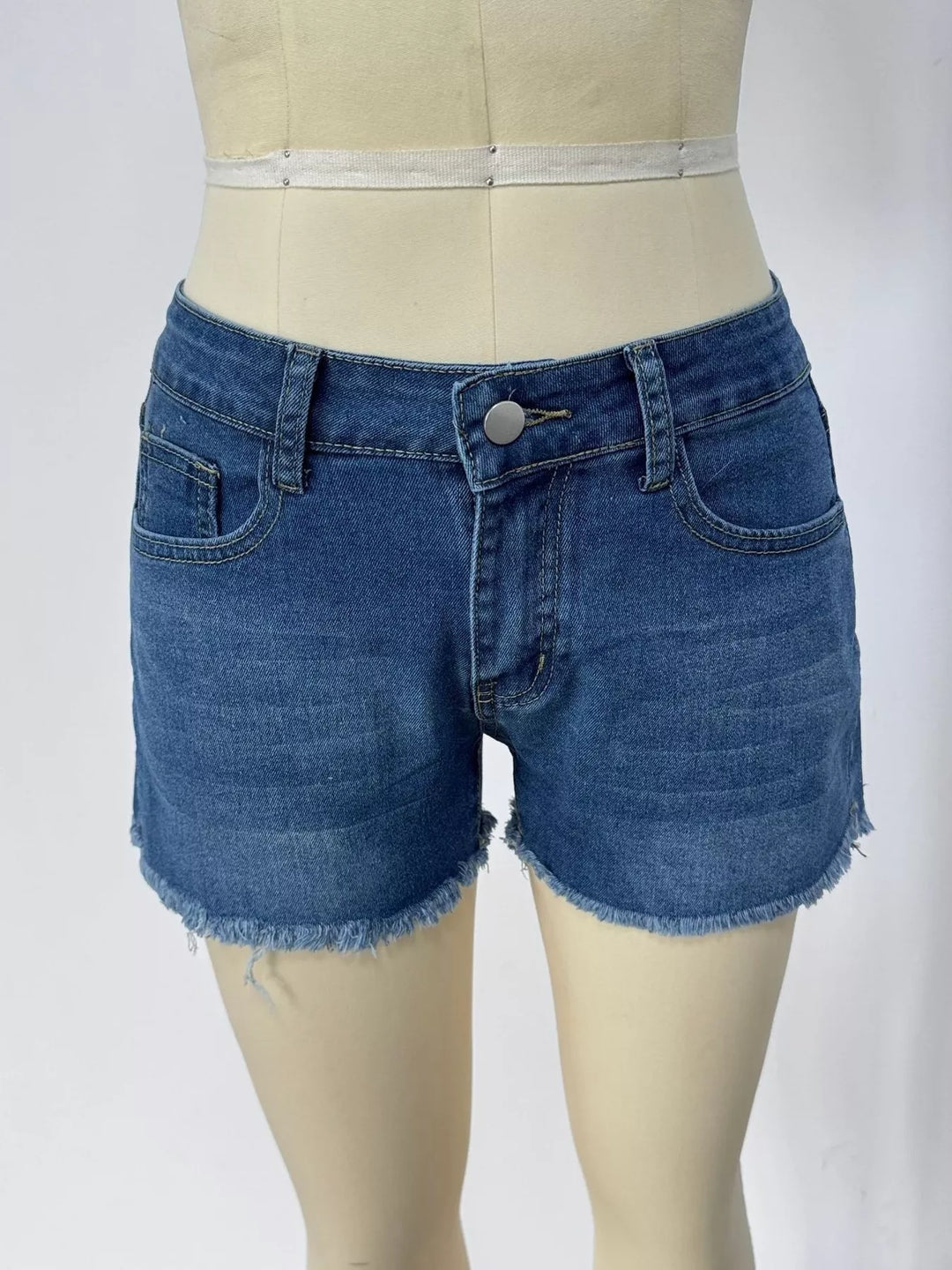 Raw hem denim shorts with frayed edges and five-pocket styling