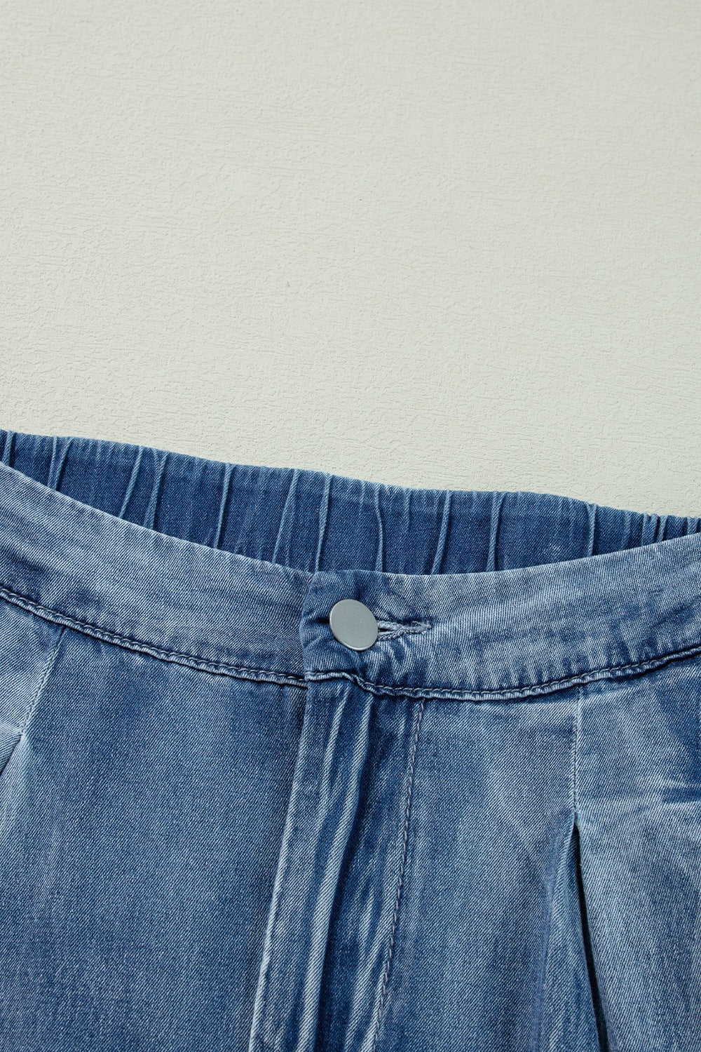 Pleated high-rise wide-leg jeans with deep pockets