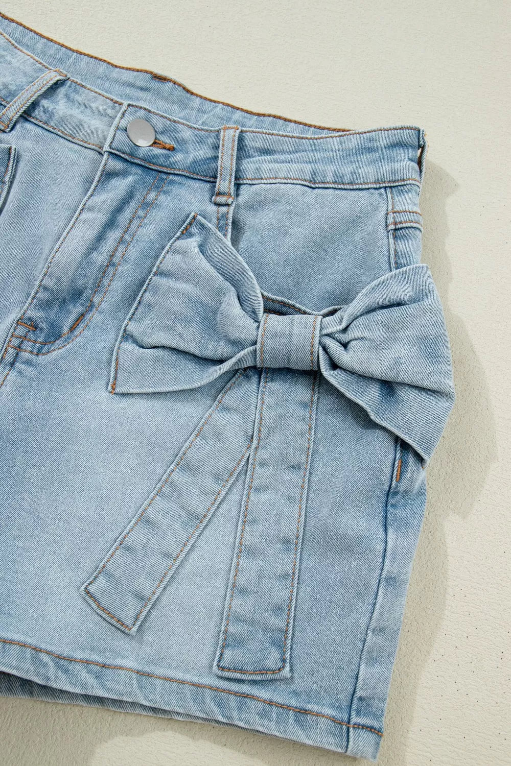 Mid-rise denim shorts with bow-tied front patch pockets