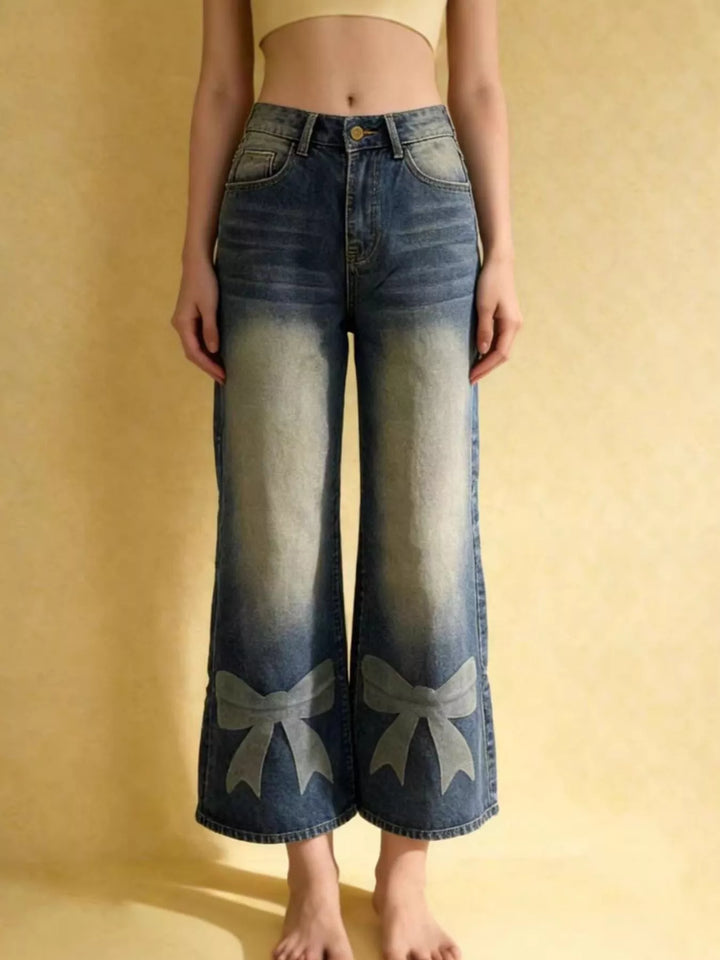 Bow-detail wide leg jeans with faded whiskering