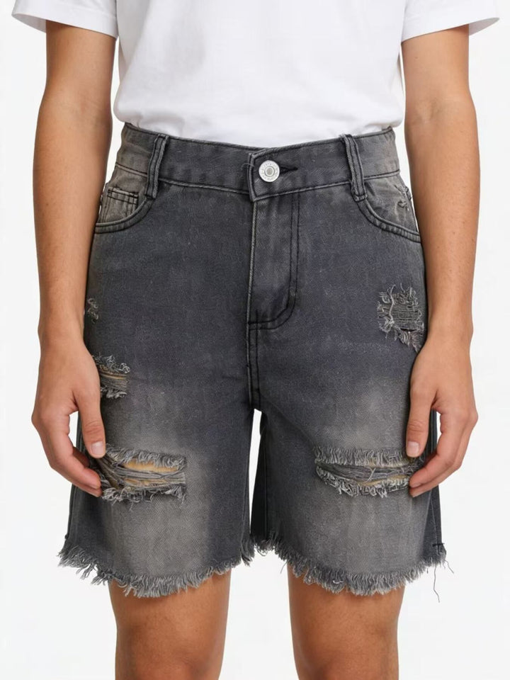 Distressed mid-thigh denim shorts with raw frayed hem