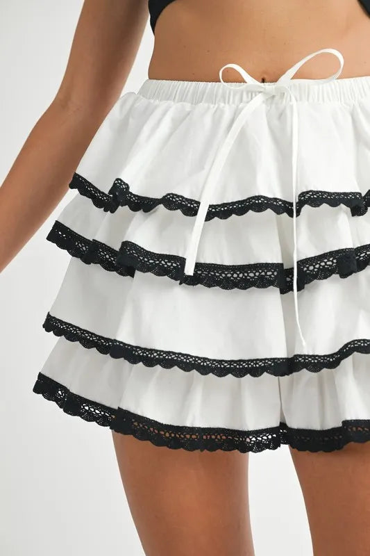 Tiered ruffle mini skirt with contrast lace trim and tie waist