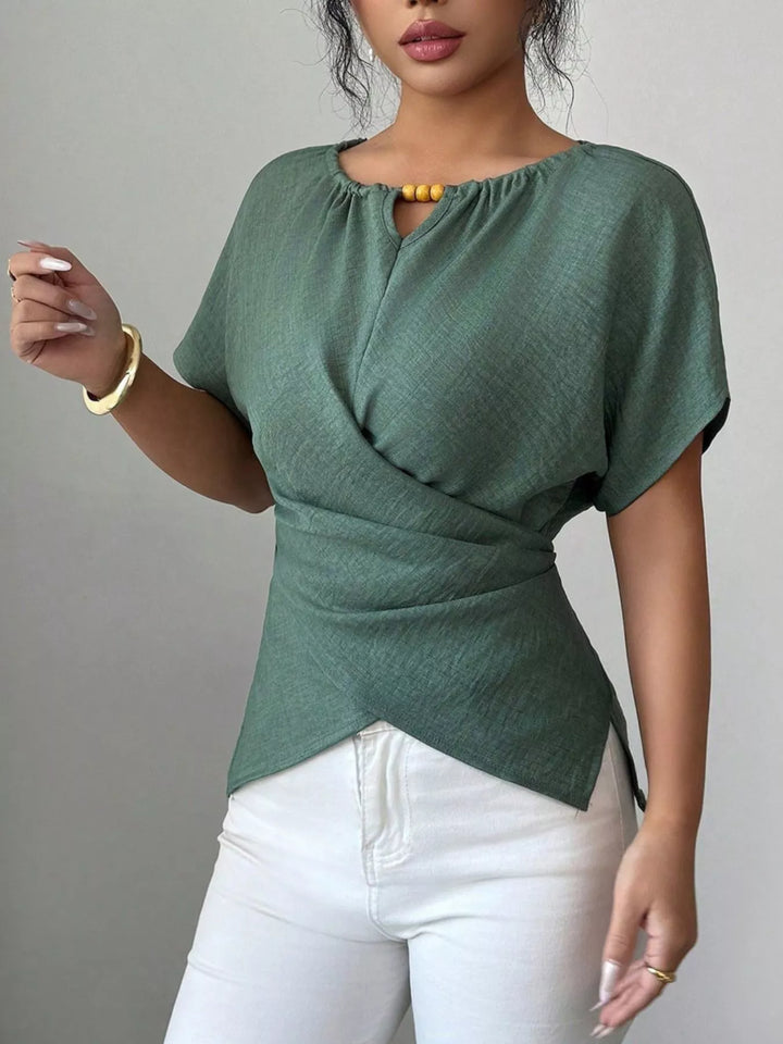 Wrap-front short sleeve blouse with beaded keyhole neckline