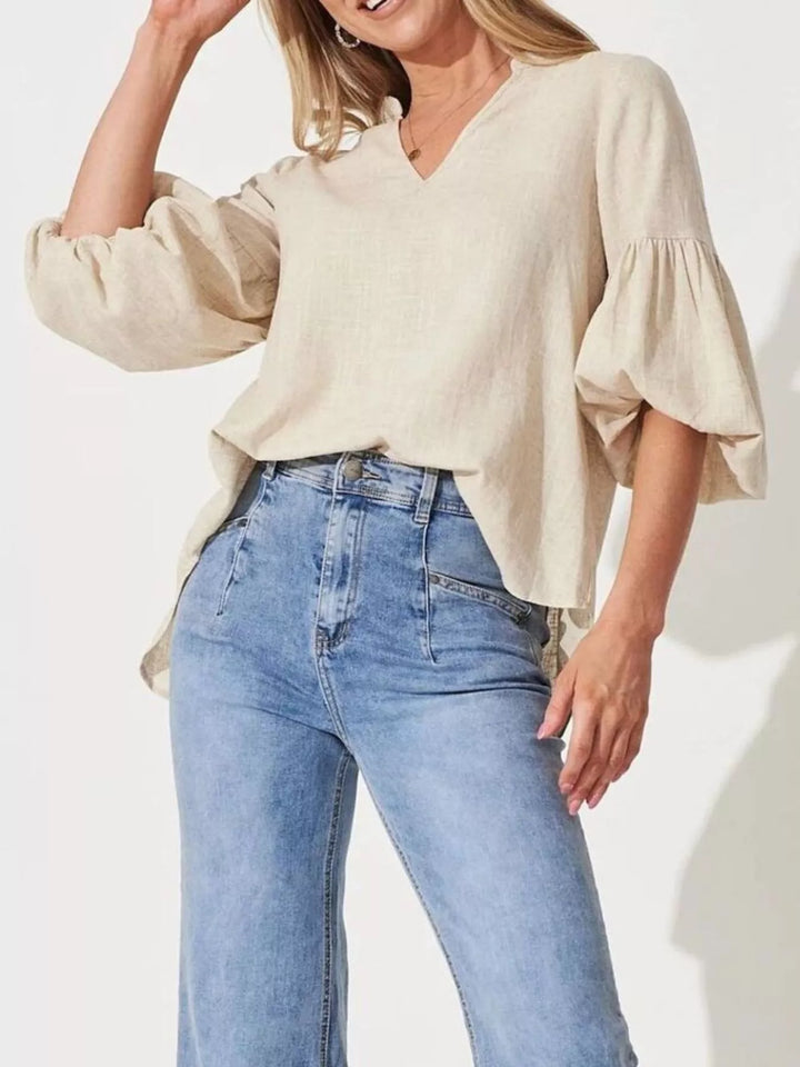 Balloon sleeve blouse with notched neckline and high-low hem