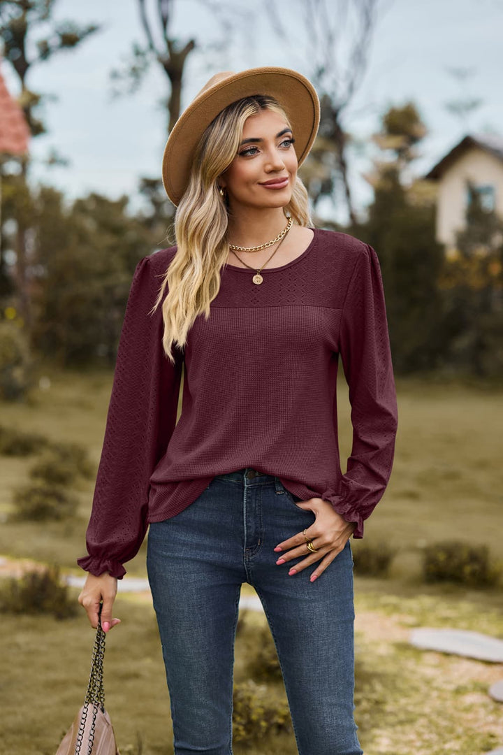 Eyelet knit puff sleeve blouse with round neckline
