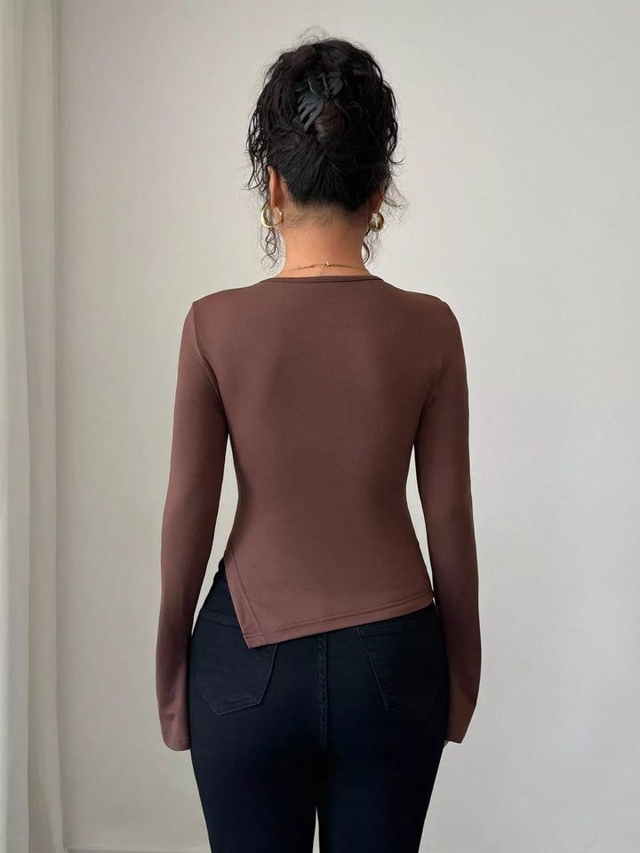 Cutout long sleeve top with gold ring and asymmetrical hem