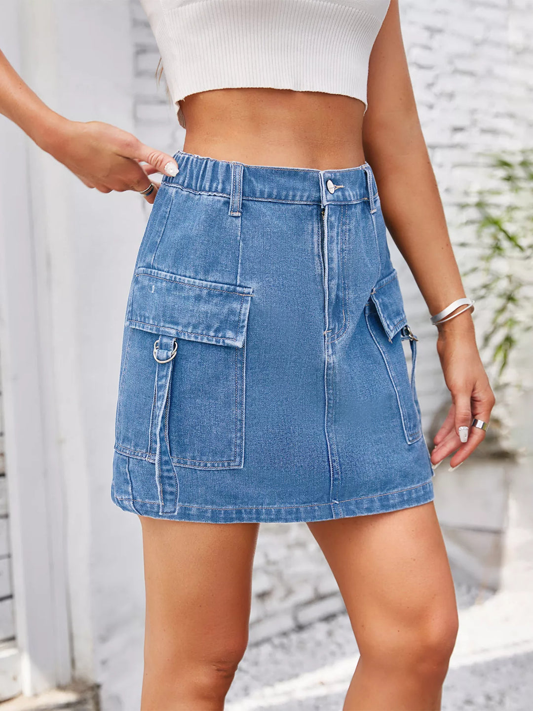 Cargo denim mini skirt with flap pockets and D-rings