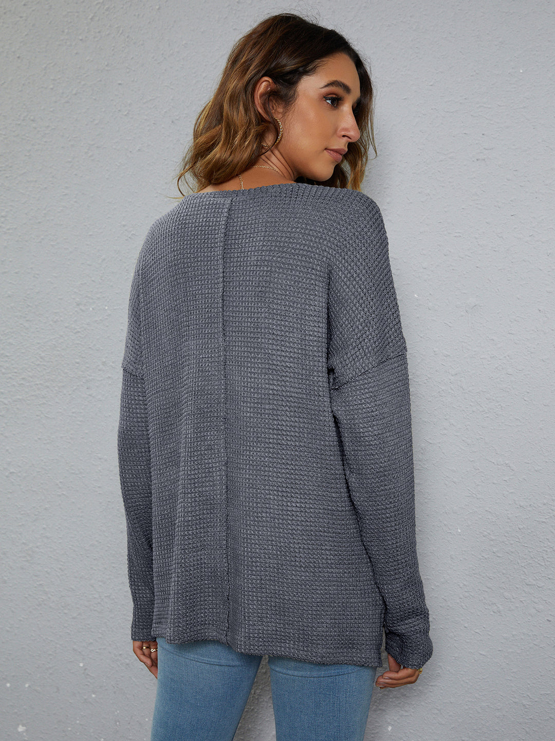 Dropped-shoulder waffle-knit V-neck top with high-low hem
