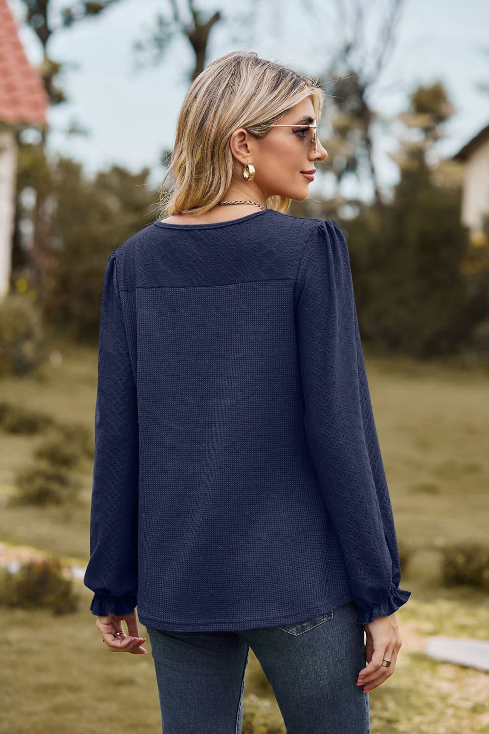 Eyelet knit puff sleeve blouse with round neckline