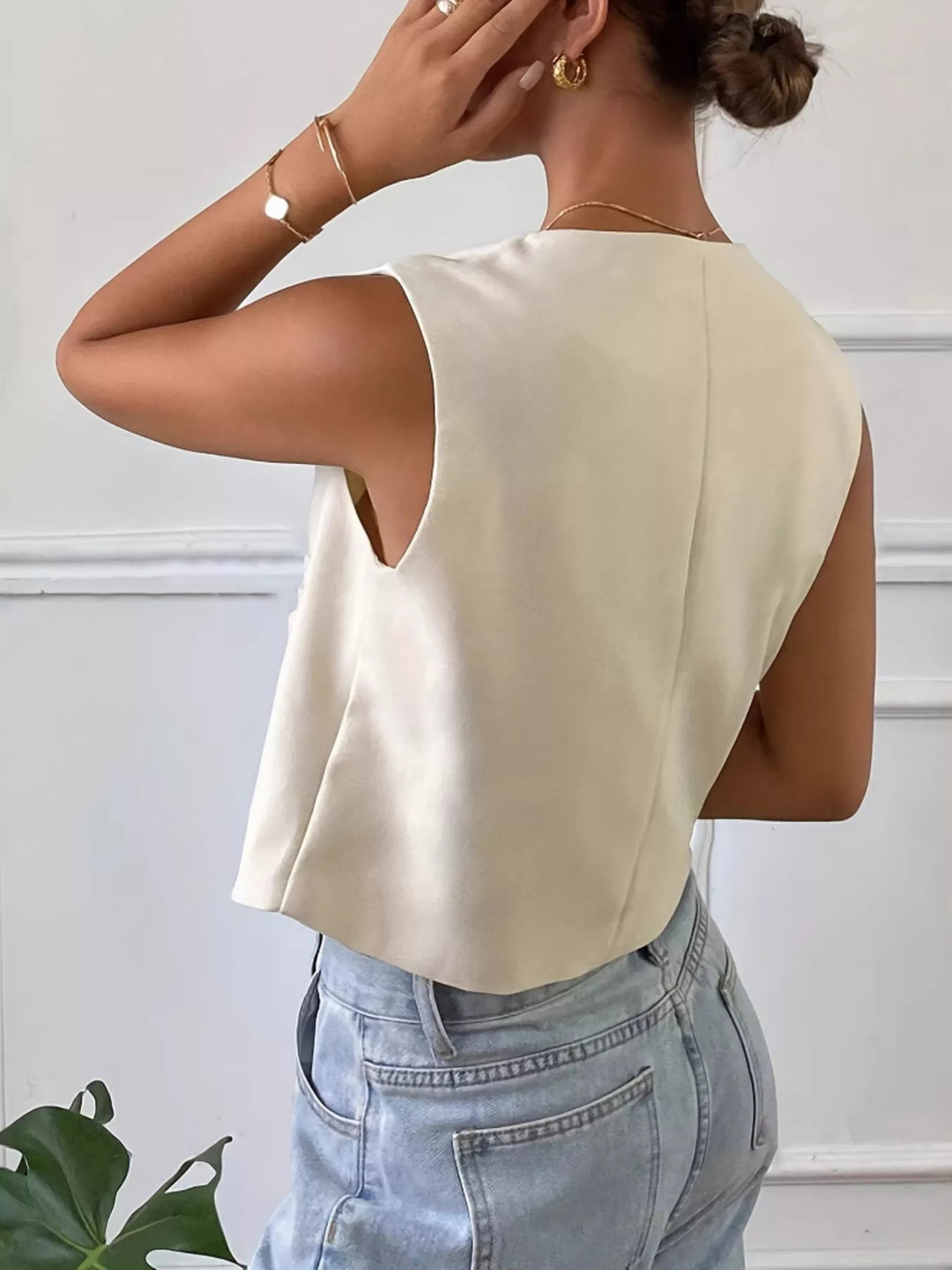 Button-down sleeveless vest with gold dome buttons and patch pockets