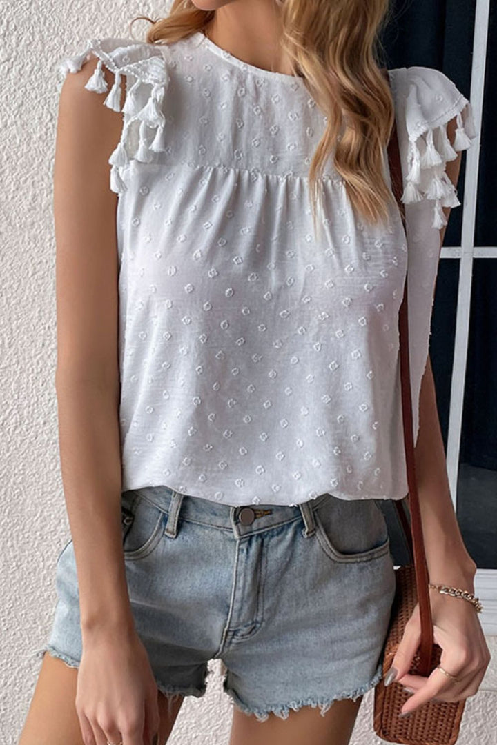 Swiss dot flutter sleeve blouse with tassel trim