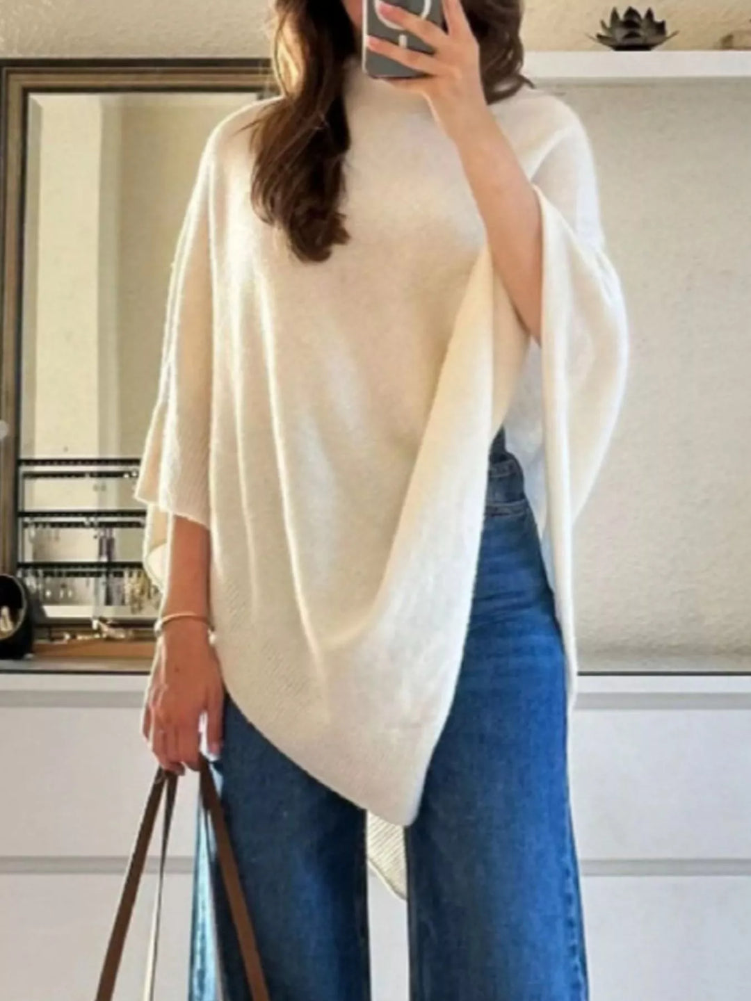 Turtleneck poncho sweater with asymmetric hem and batwing sleeves