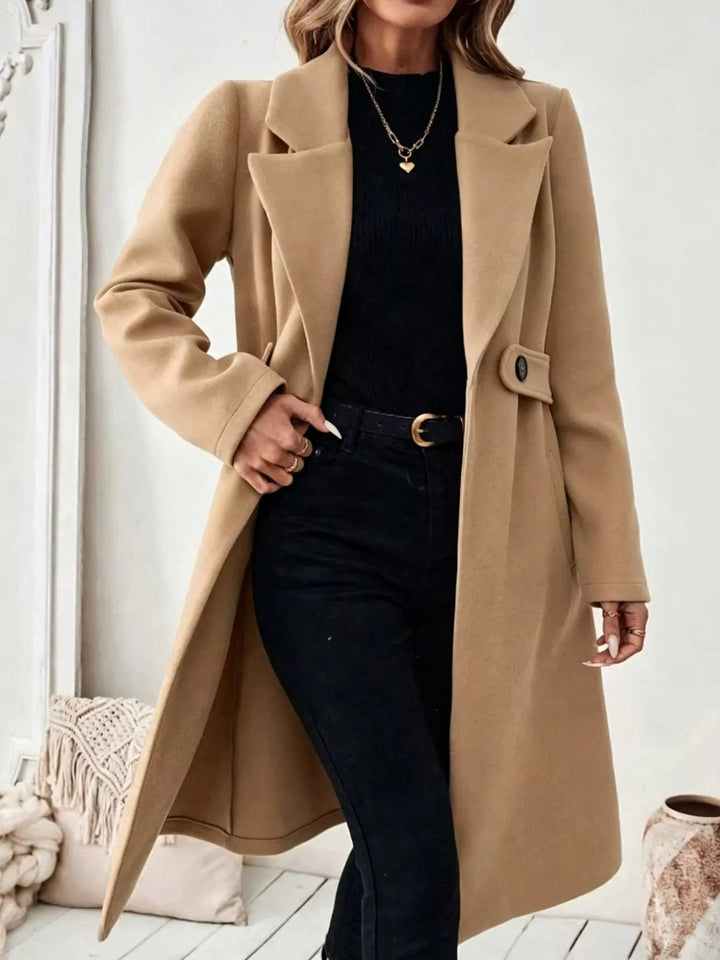 Longline notch lapel coat with single-button waist tab