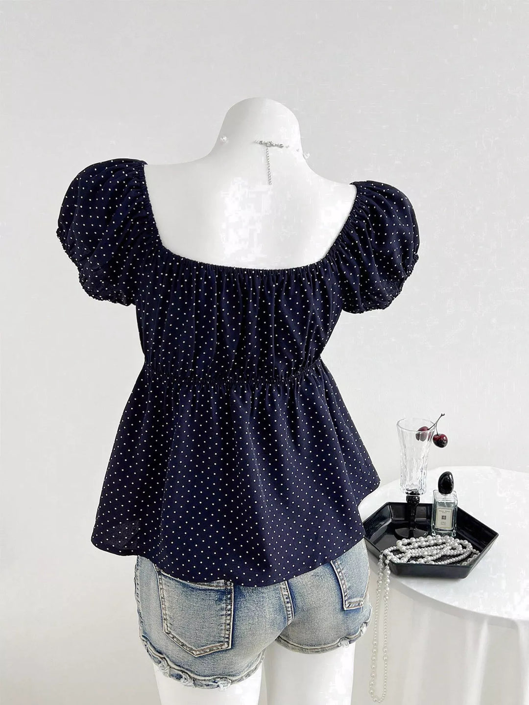 Polka dot scoop-neck peplum blouse with puff sleeves