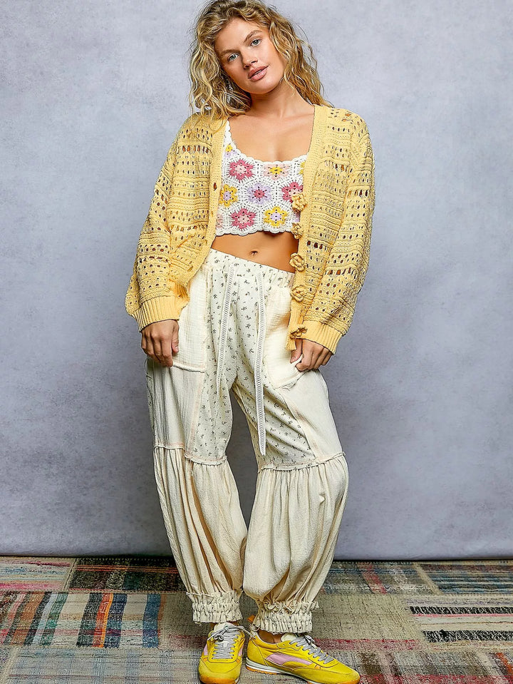 Open-knit V-neck cardigan with 3D floral button closure