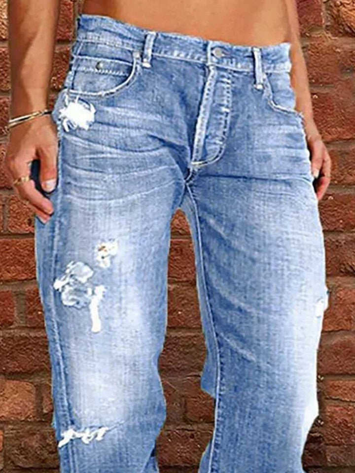 Distressed loose fit straight leg jeans with raw hem