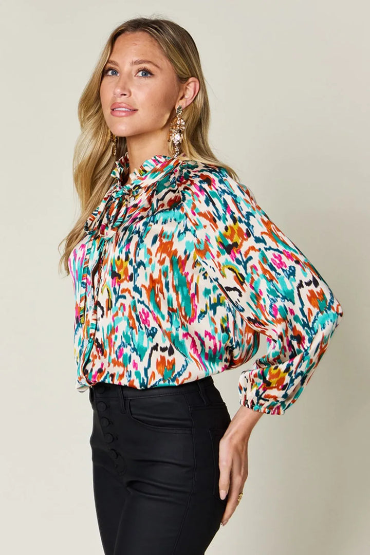 Abstract print button-up shirt with tie neck and long sleeves