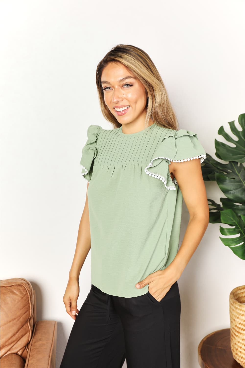 Pintuck yoke flutter sleeve blouse with pom-pom trim