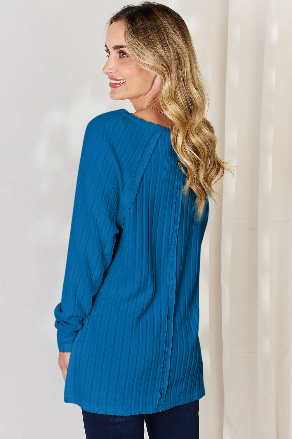 Ribbed knit round neck long sleeve top with side slits