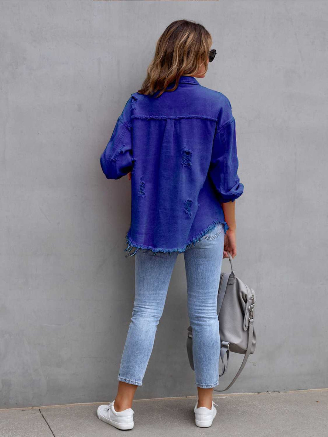 Distressed drop shoulder denim jacket with fringe hem
