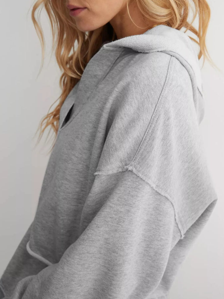 Cropped exposed-seam pullover hoodie with split neck
