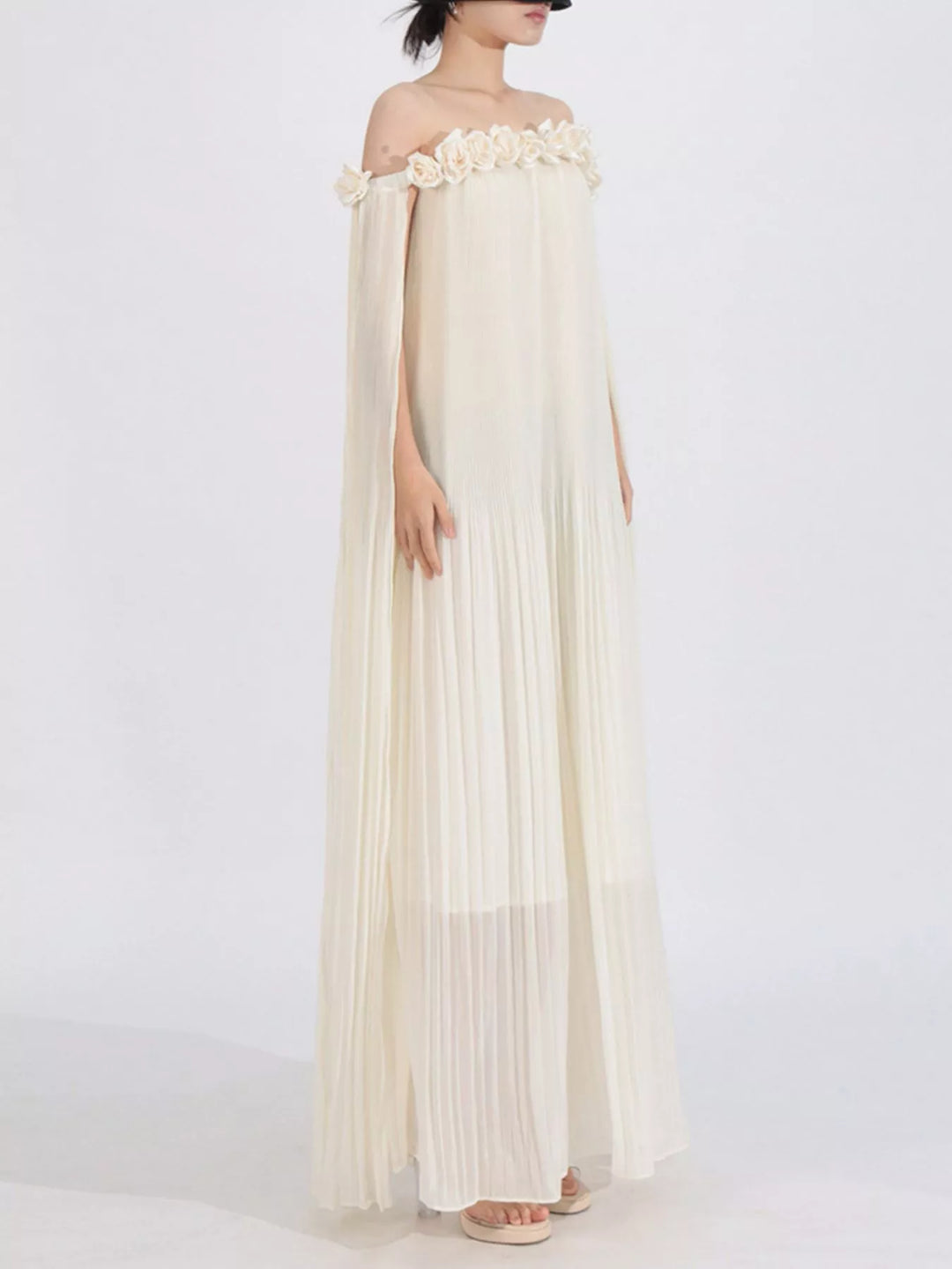 Off-shoulder pleated maxi dress with rosette neckline