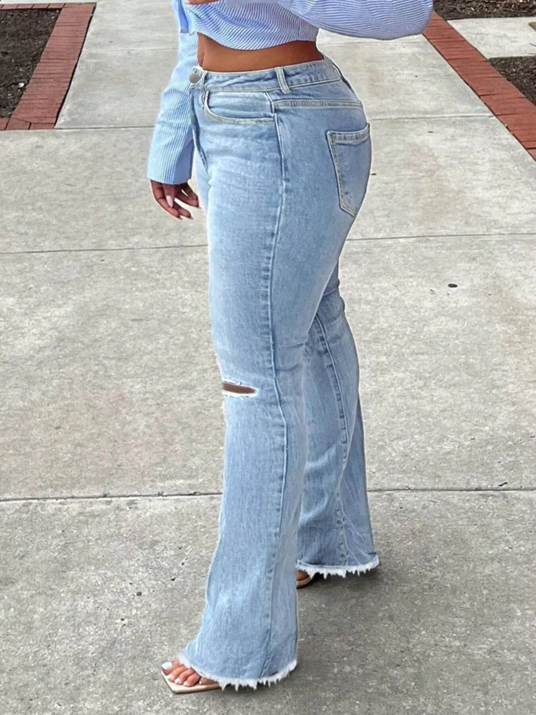 High-rise ripped knee flare jeans with raw hem