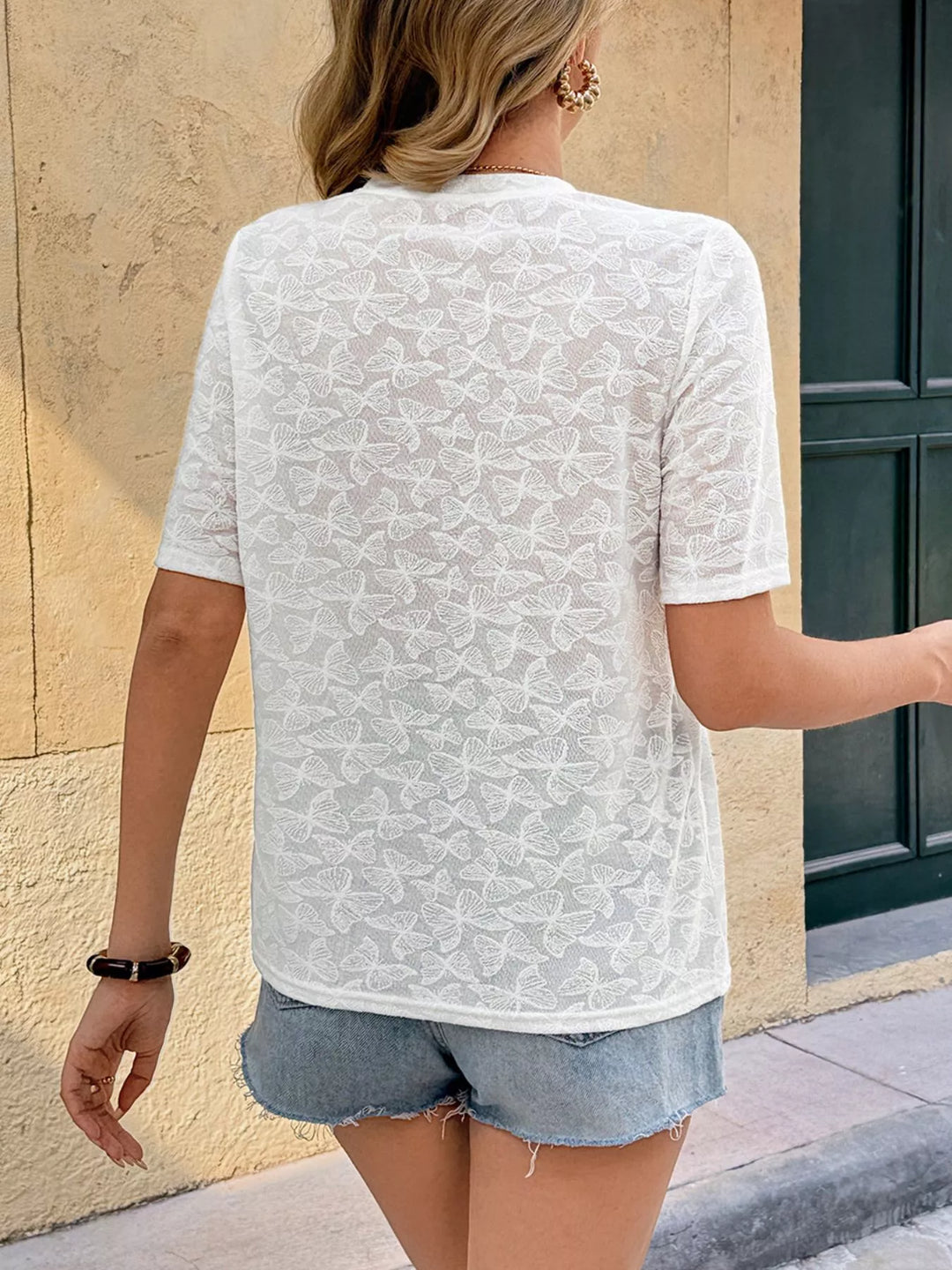 Butterfly-textured round neck top with pearl bow