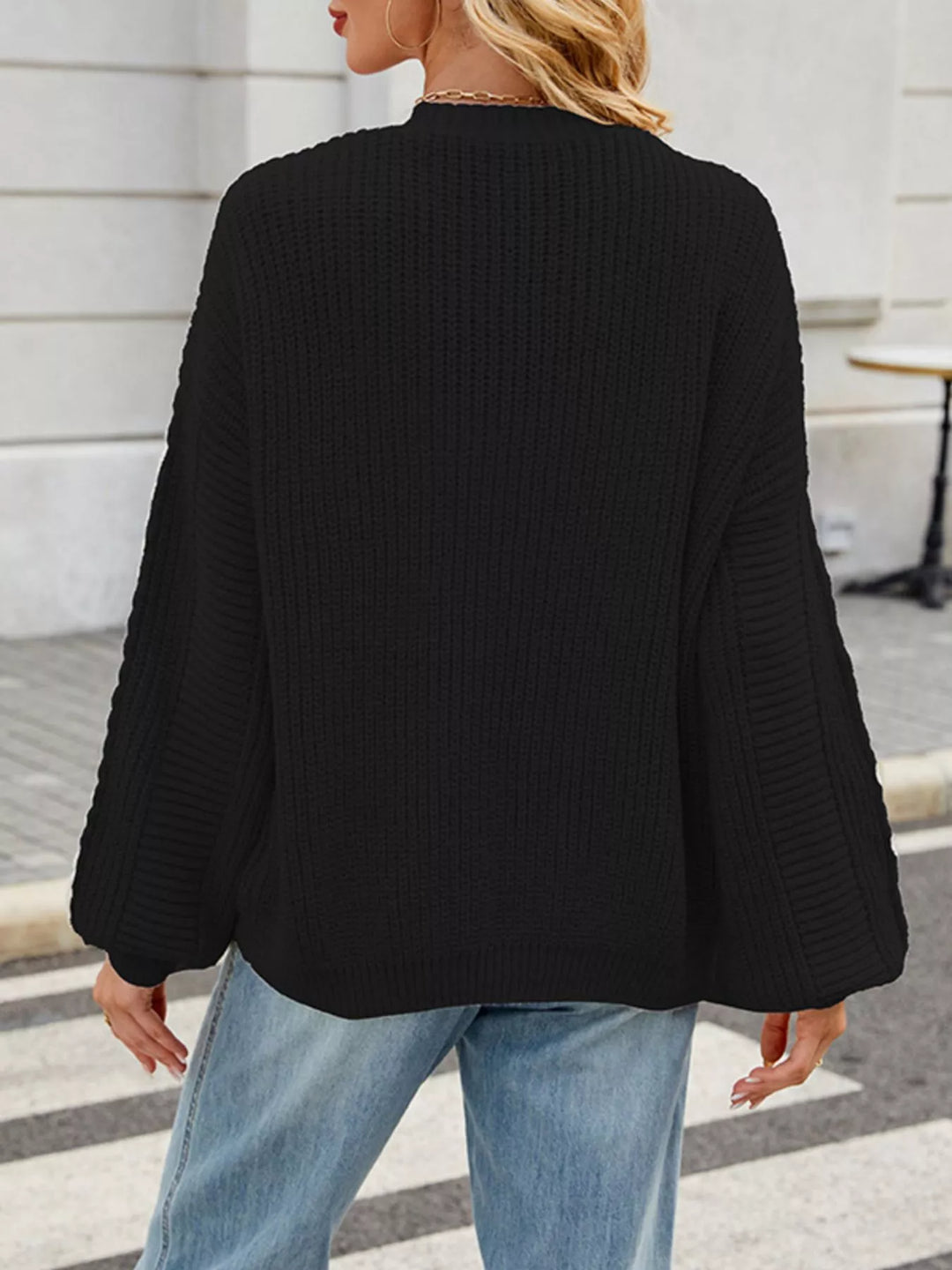 Cable knit button-front cardigan with drop shoulder sleeves