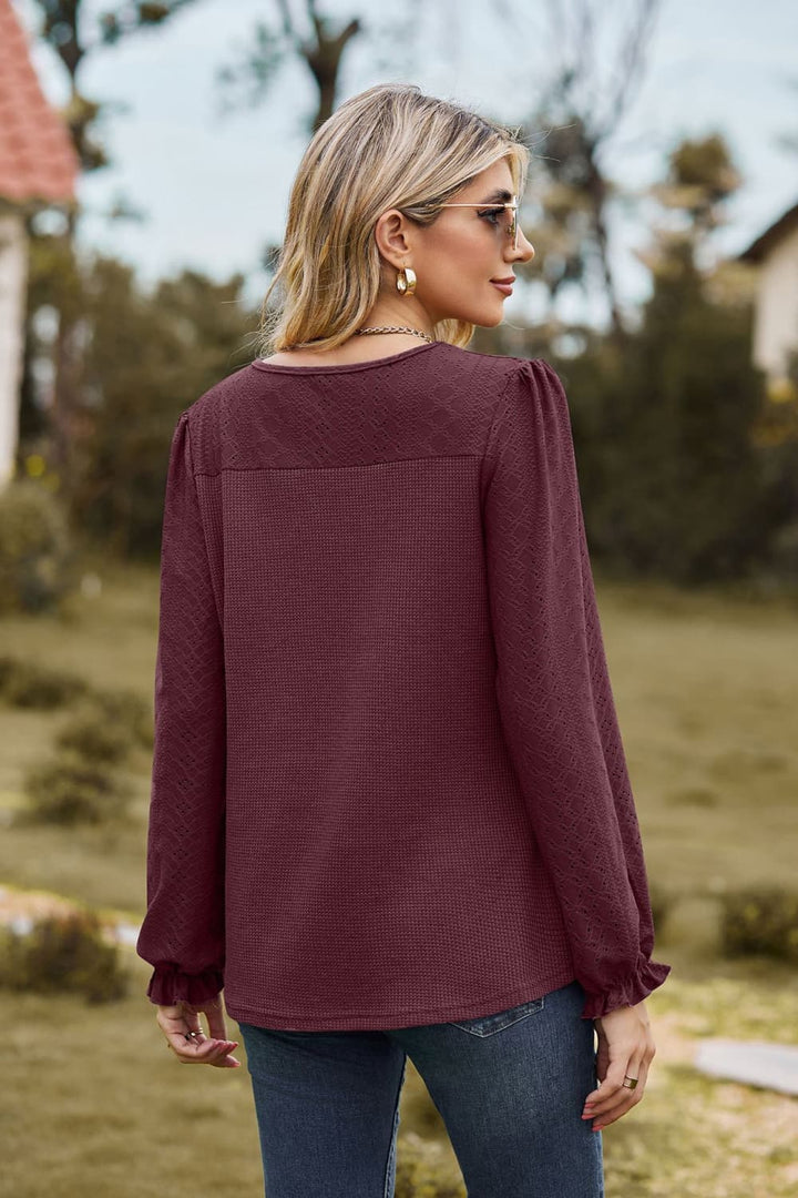 Eyelet knit puff sleeve blouse with round neckline