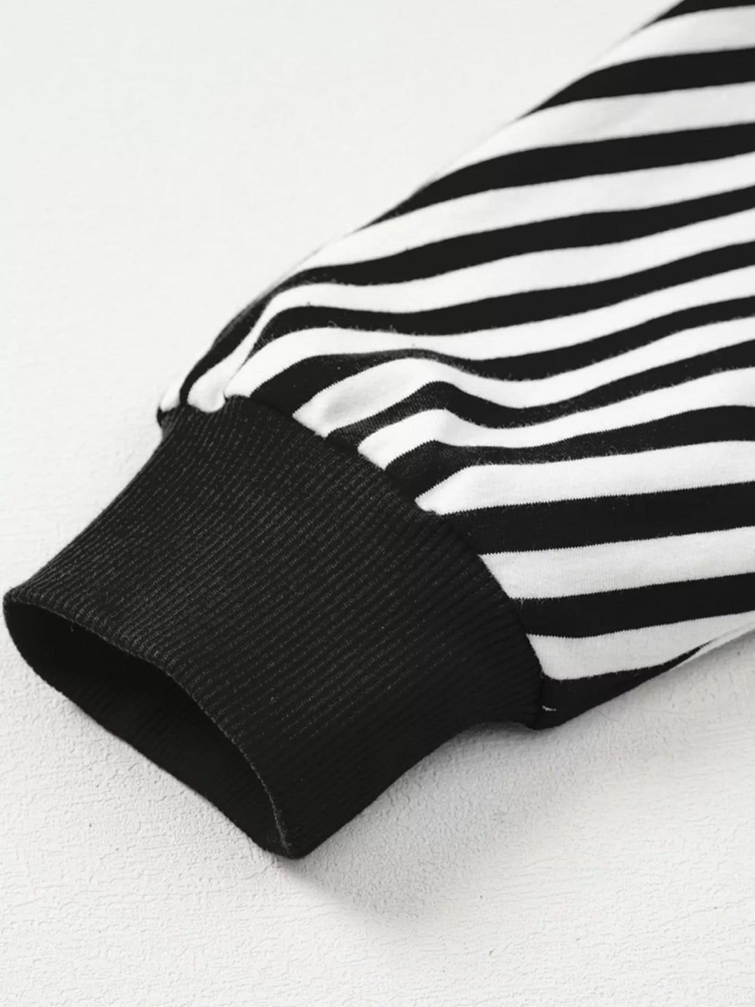 Exposed seam striped drop-shoulder pullover top