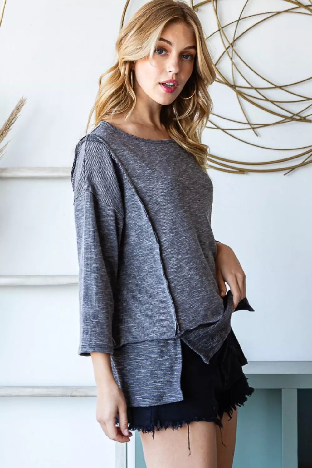 Exposed seam boat neck ribbed knit top with side slits