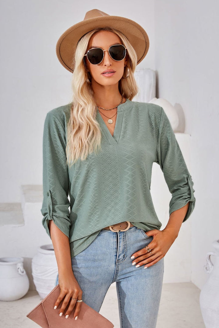 Textured split v-neck blouse with roll-tab sleeves