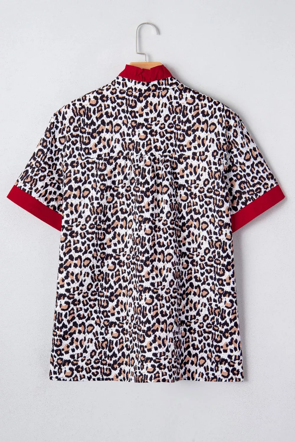 Leopard print short sleeve button-down with contrast ruffle trim