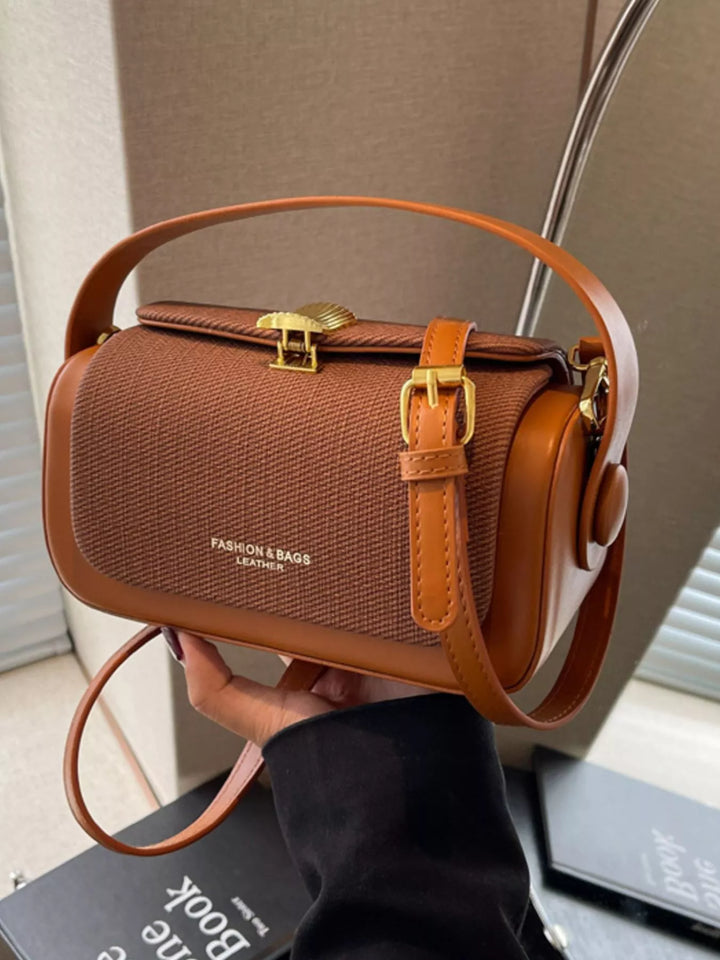 Structured boxy crossbody bag with gold clasp and top handle