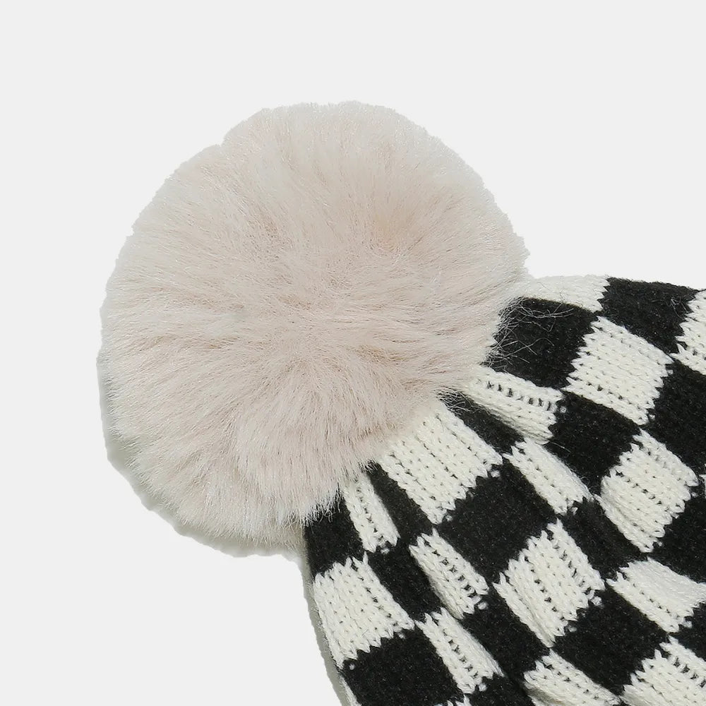 Checkerboard knit beanie with faux fur pompom