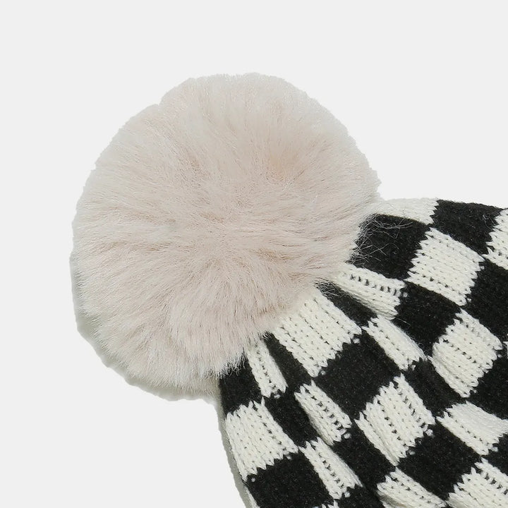 Checkerboard knit beanie with faux fur pompom