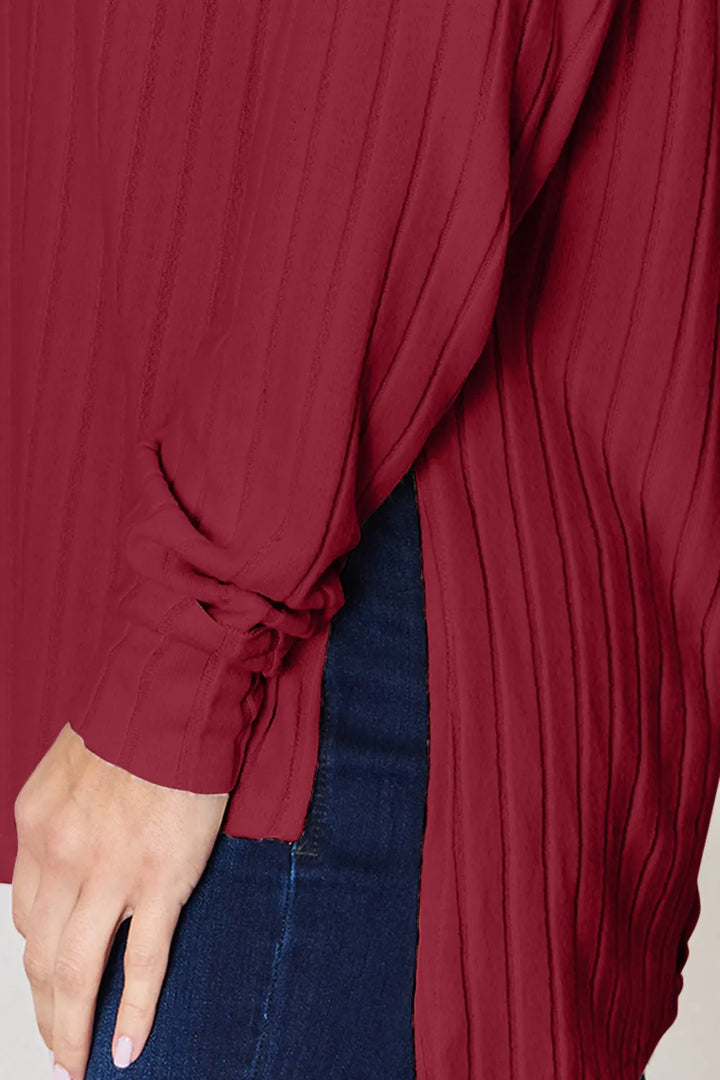 Ribbed knit round neck long sleeve top with side slits