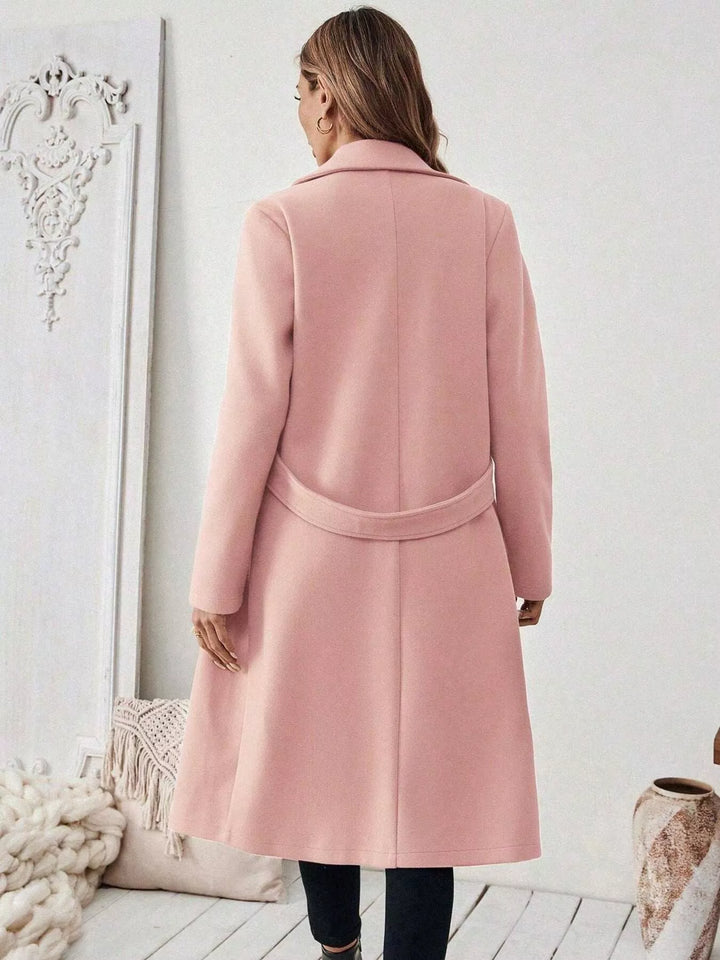 Longline notch lapel coat with single-button waist tab