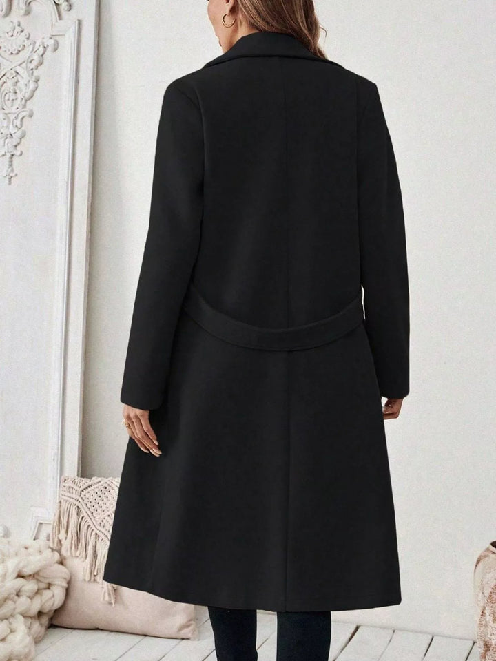 Longline notch lapel coat with single-button waist tab