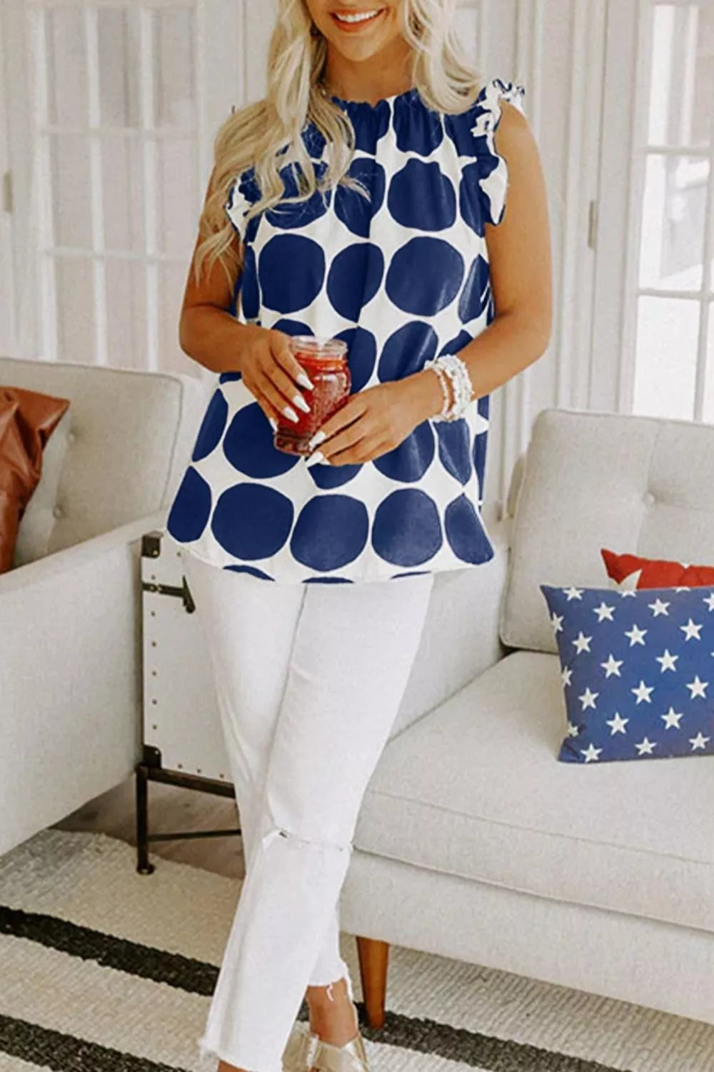 Polka dot sleeveless top with ruffle neck and shoulders
