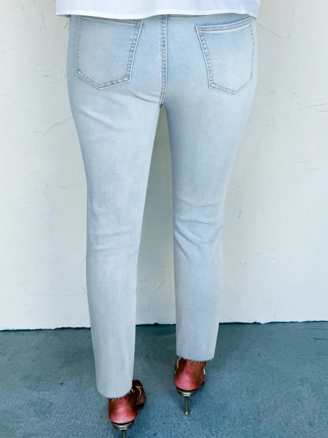 Distressed mid-rise ankle skinny jeans with raw hem