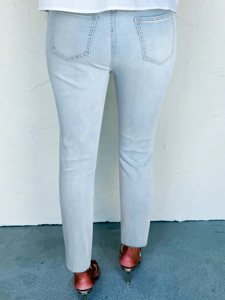 Distressed mid-rise ankle skinny jeans with raw hem