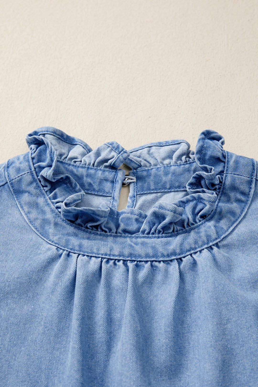 Frayed flutter sleeve denim top with frilled mock neck