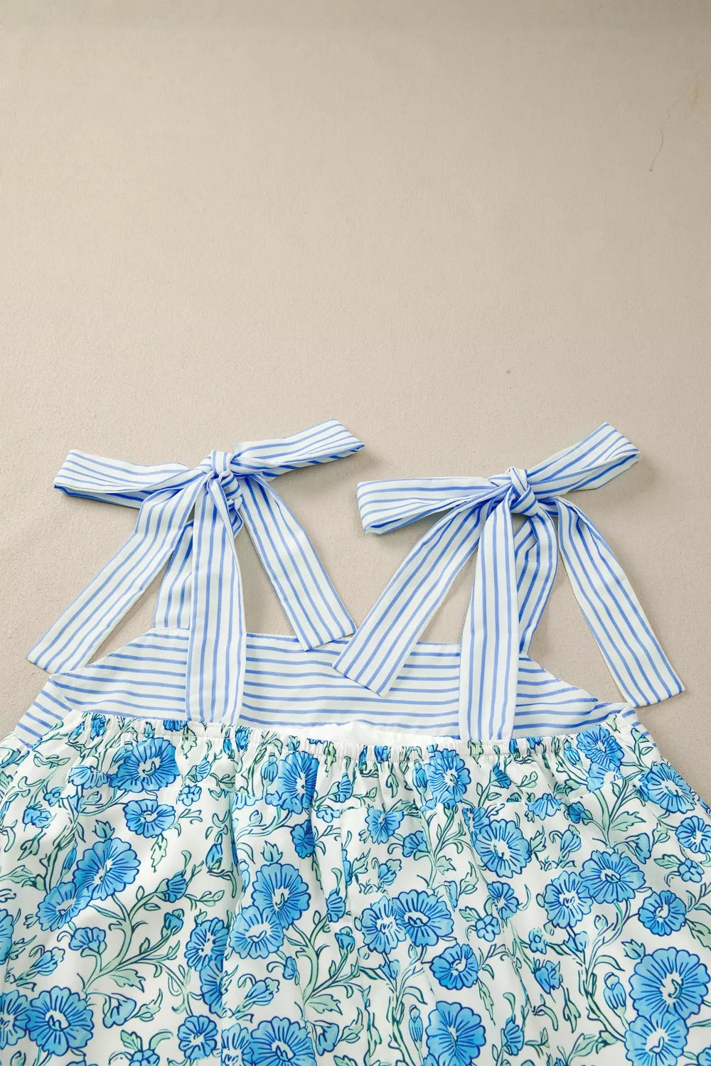 Floral babydoll mini dress with striped tie straps