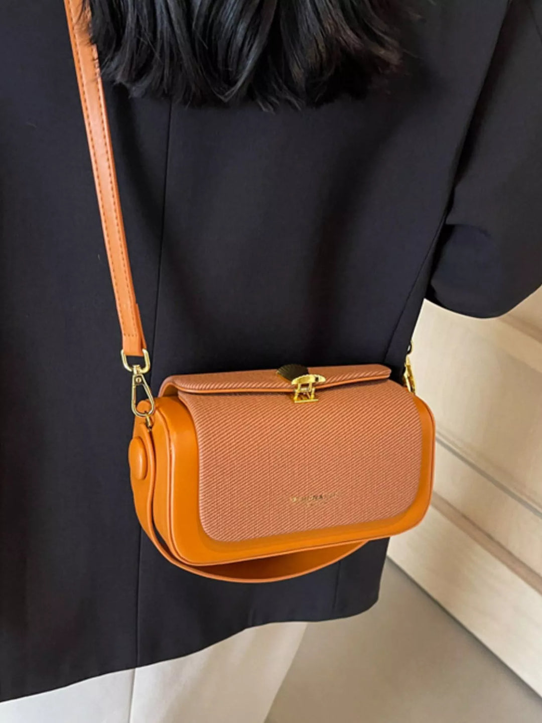 Structured boxy crossbody bag with gold clasp and top handle