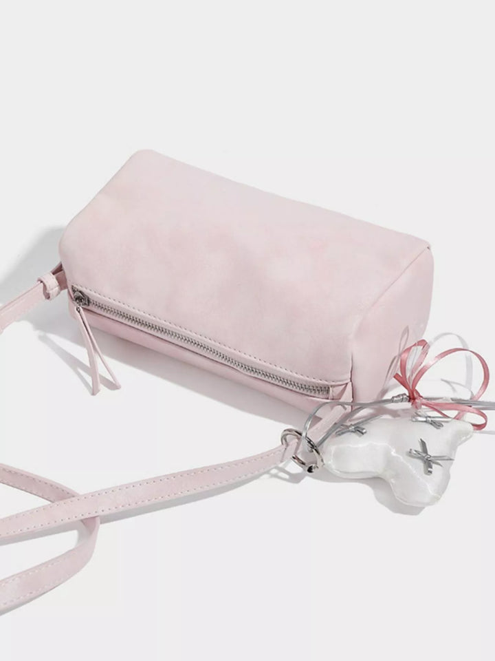 Adjustable strap crossbody bag with heart charm and bow trim