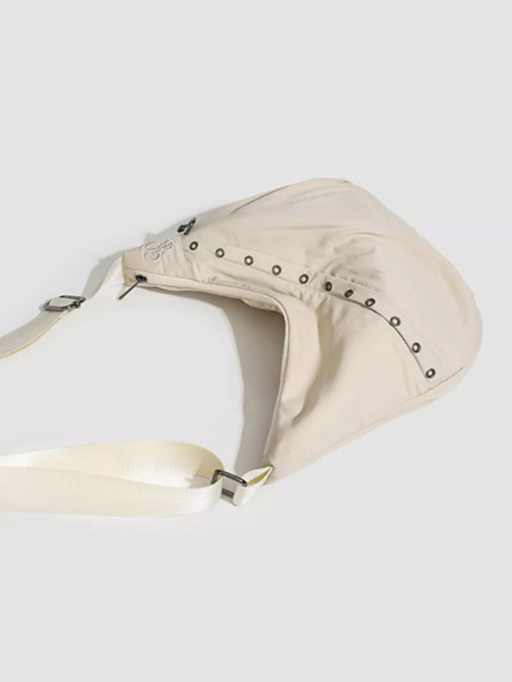 Grommet-studded nylon crossbody sling bag with zip pockets