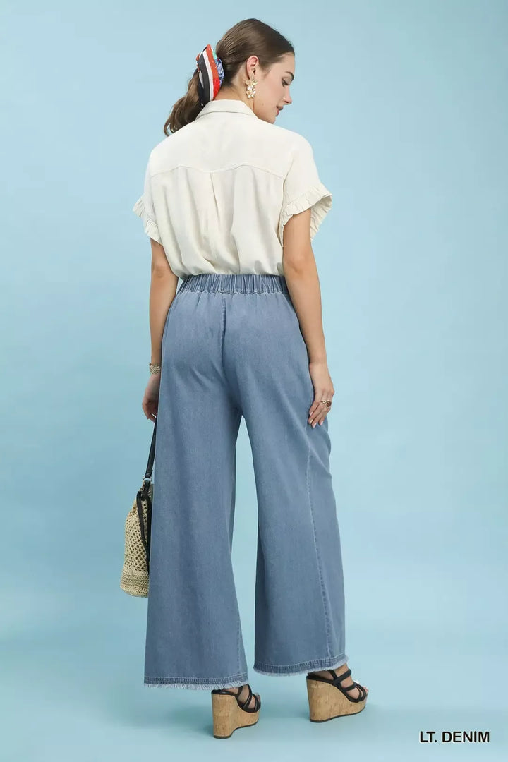 Stone washed wide-leg cotton pants with raw frayed hem