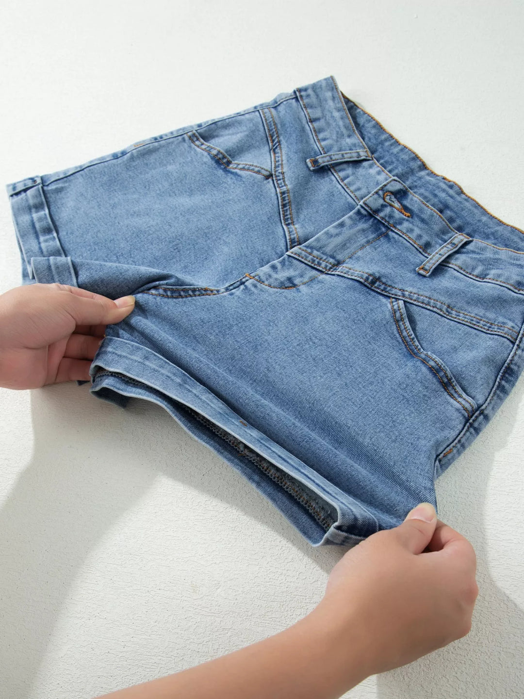 High-rise cuffed denim shorts with double-button waist